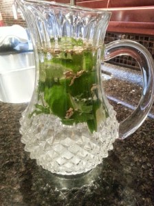 Water with sliced lime, mint leaves and ginger root.