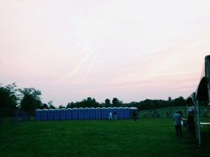 A line of portable washrooms without a handwash station. Deee-licious!