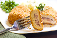 stuffed-chicken-cordon-bleu-breaded-green-peas-white-rice-parsley-garnish-48818189